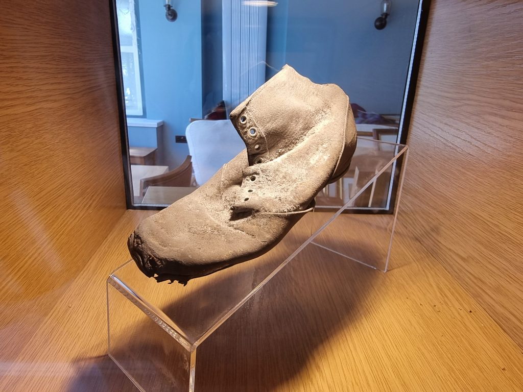 The well-worn child’s shoe discovered within the walls of Min y Don—an age-old tradition believed to protect the home and those within it.