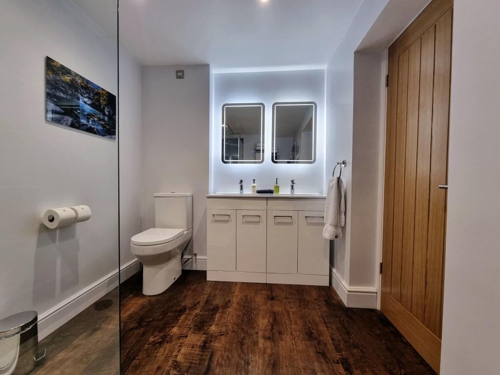 Luxury bathroom in Suite 101 with twin sinks, LED mirrors, shaver sockets and comfort-height toilet