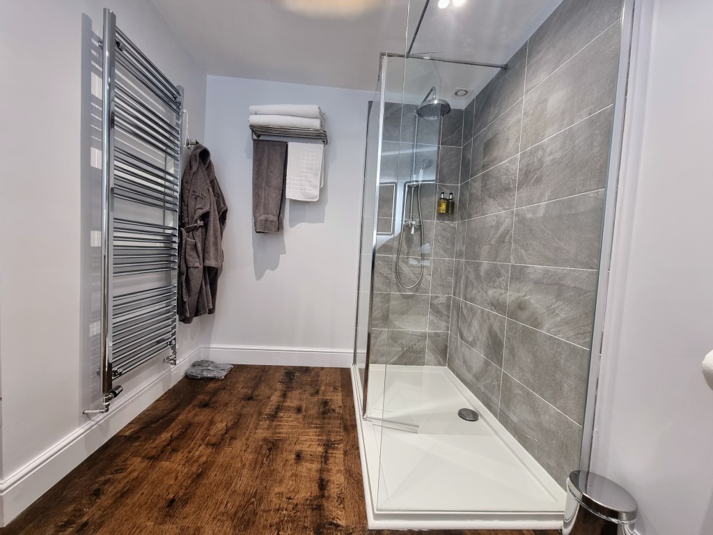 Walk-in non-slip shower with rainfall head, towels, dressing gown and heated towel rail in Suite 101