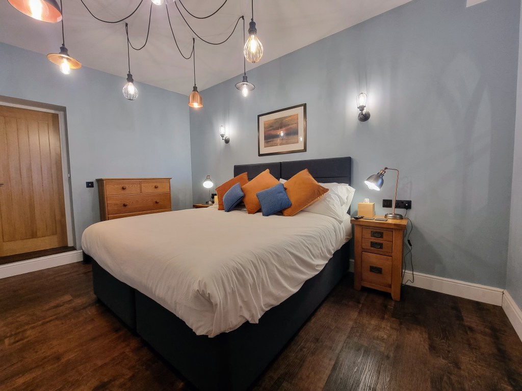 Super king bed with bedside lamps and USB charging points in Suite 101 bedroom