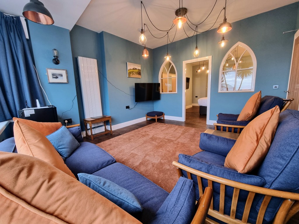 Lounge with 50-inch Smart TV and Ercol seating in Suite 101