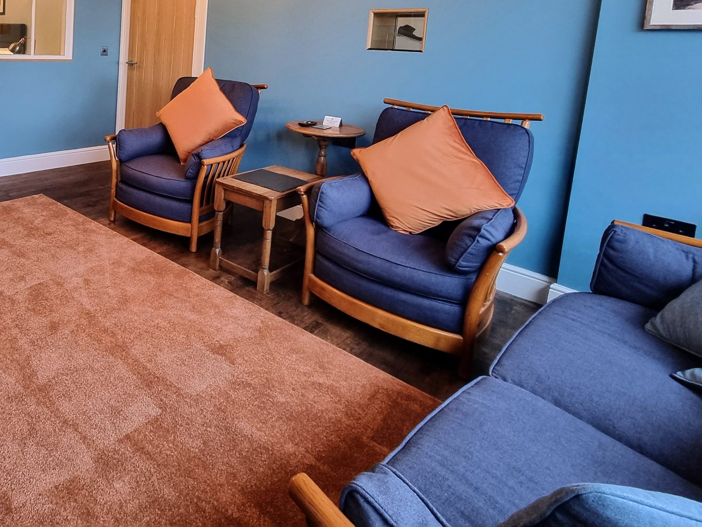 Lounge with view through doorway and arch windows into bedroom in Suite 101