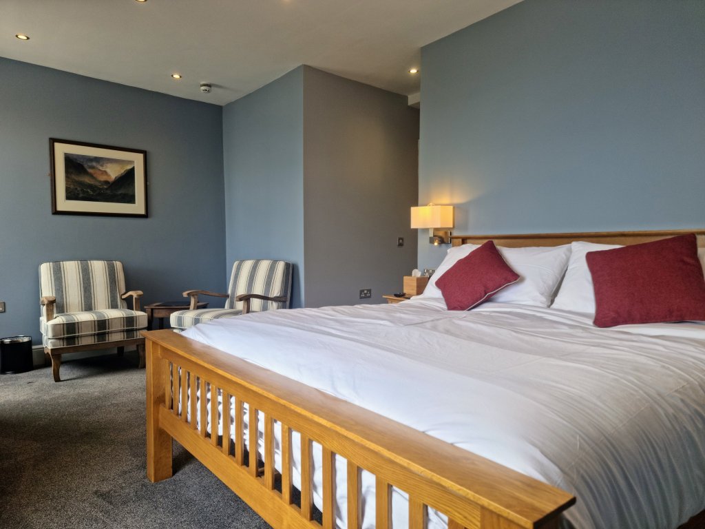 Alternative view of Room 103 showing the super king bed, seating area and room layout.