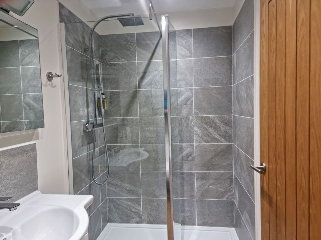 Non-slip walk-in shower in the newly refurbished Room 103 bathroom.