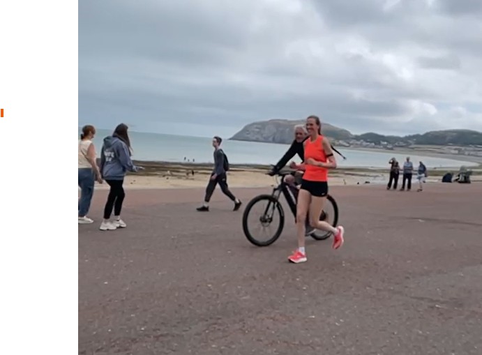 Teresa running along Llandudno Promenade during a training session for the Conwy Half Marathon. The seafront and coastline provide a scenic backdrop as she builds fitness for the 13.1-mile challenge, raising funds for the Wales Air Ambulance Service.