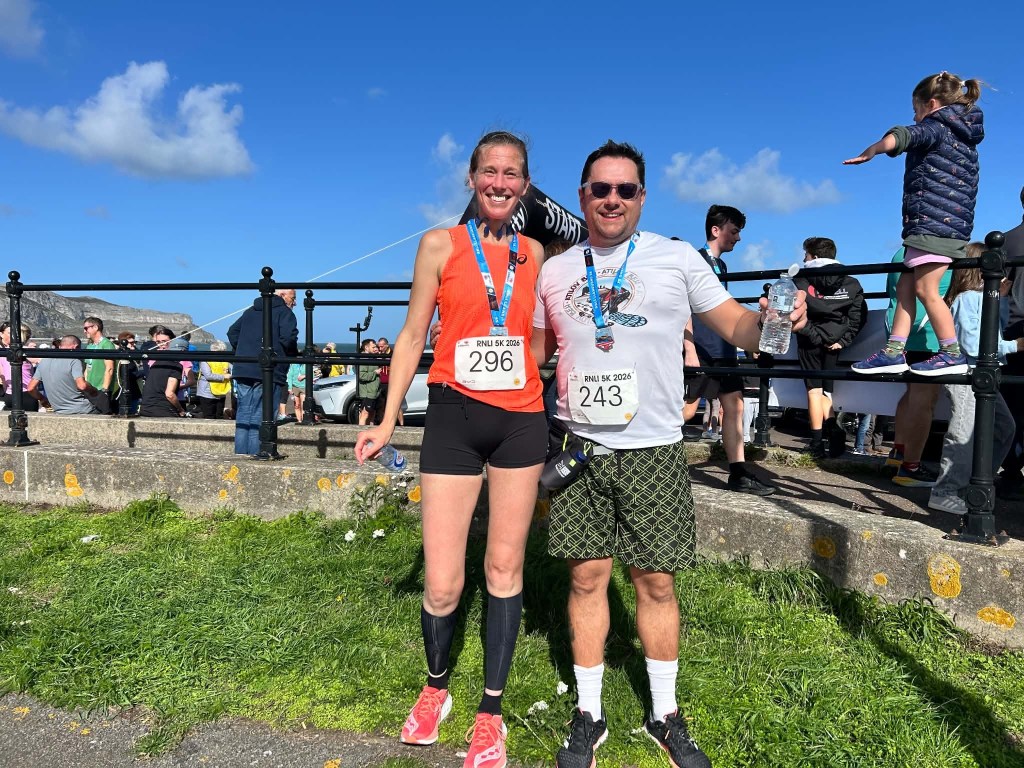 Teresa and Peter Greno pose together after completing the RNLI Fun Run in Llandudno, celebrating a successful morning of running and fundraising.