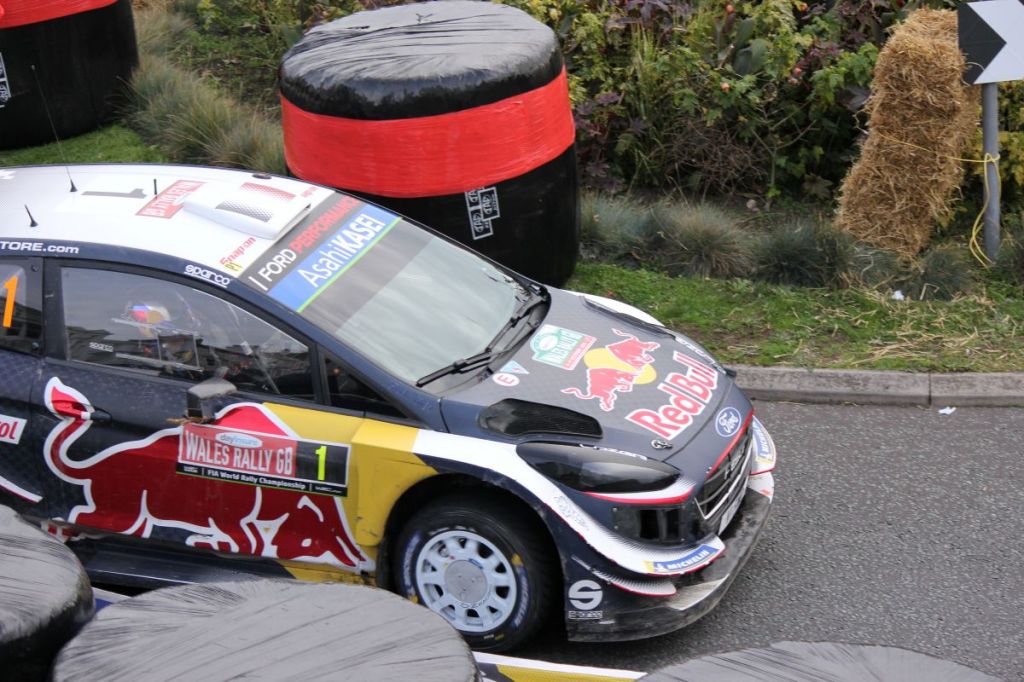 WRC rally car passing Min y Don on Llandudno Promenade during Wales Rally GB on 7 October 2018.